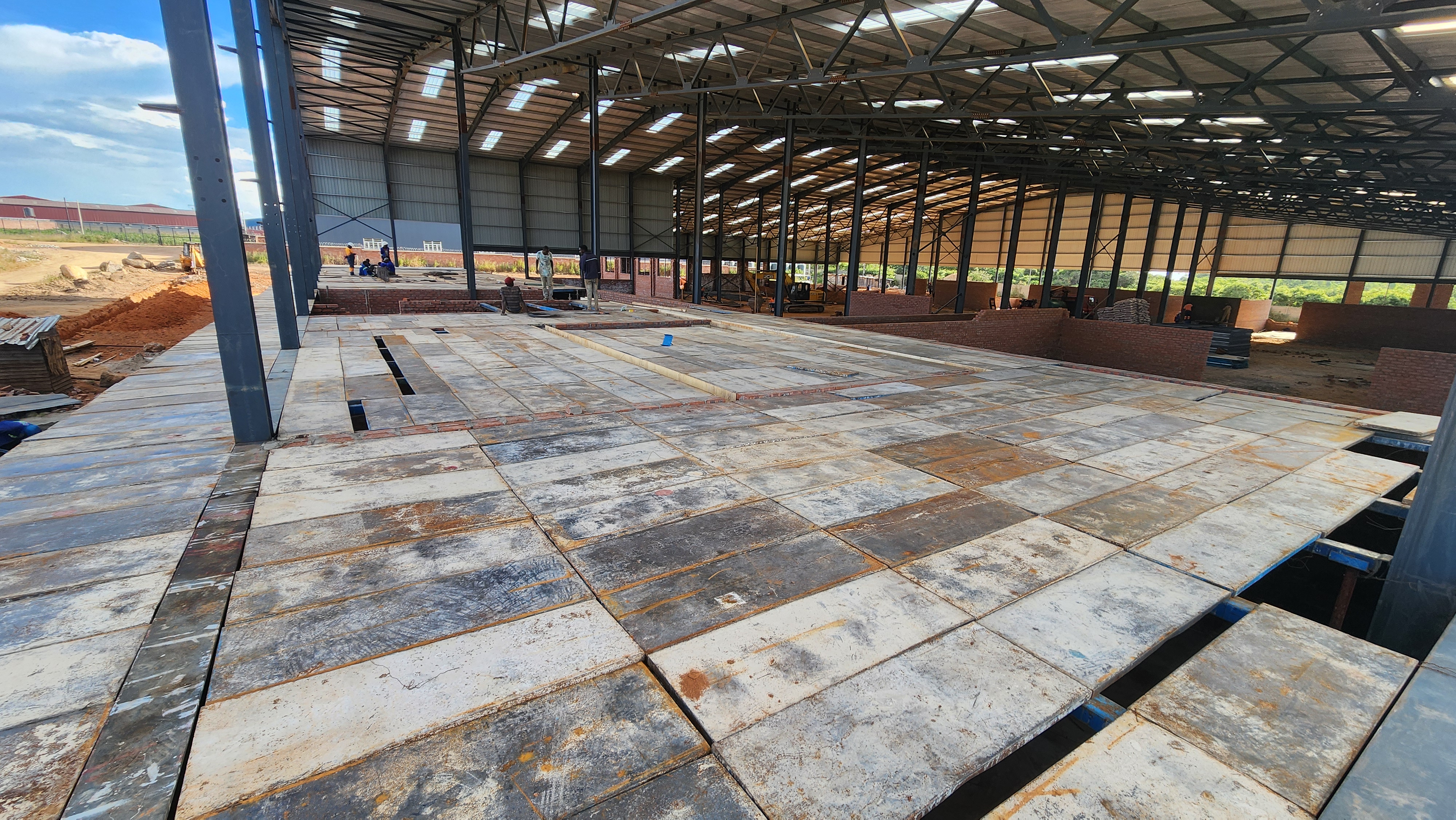 Wide interior view of a large steel structure with deckpan panels